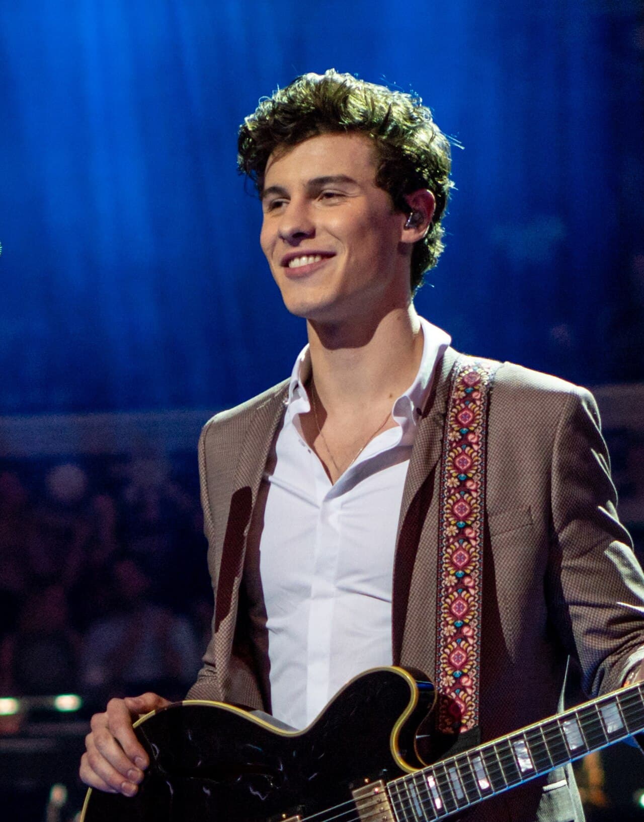 Shawn Mendes playing guitar on stage