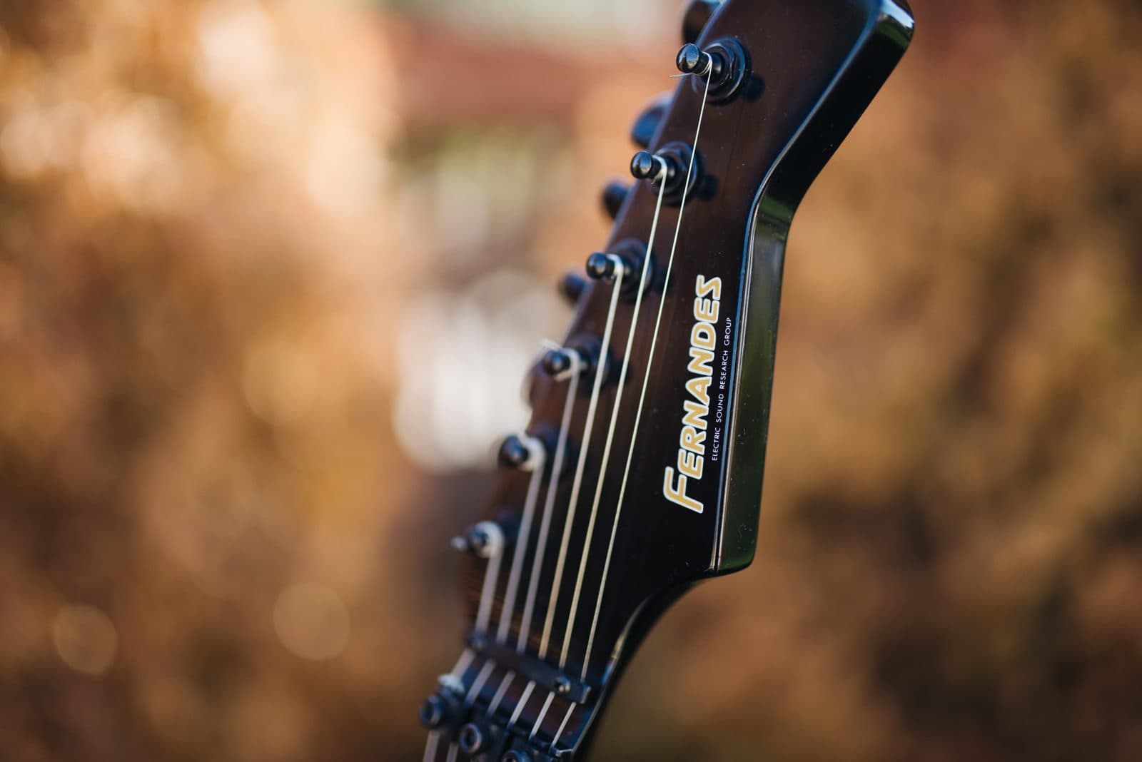 The headstock and tuners of a Fernandes electric guitar.