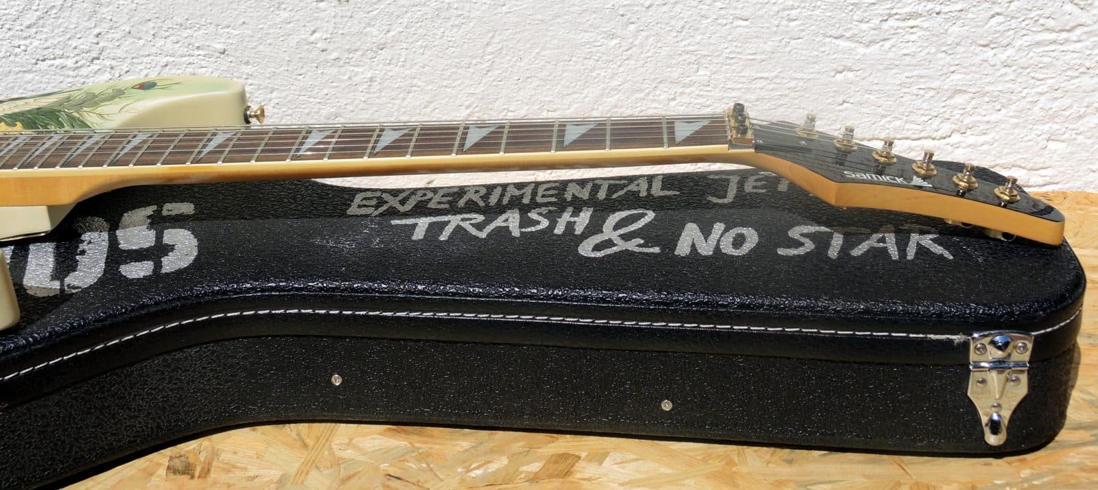 Side view of a Samick electric guitar neck and fretboard.