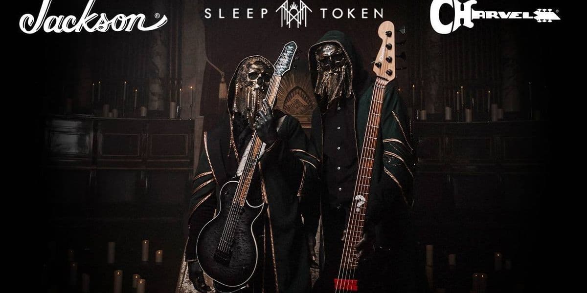 Sleep Token's masked guitarist IV and bassist III holding their new signature Jackson Monarkh SC and Charvel San Dimas Bass V in front of a candlelit altar