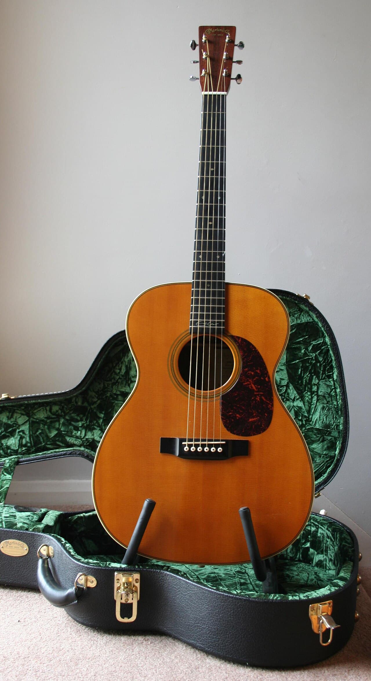 A Martin 000-28 acoustic guitar resting in its case